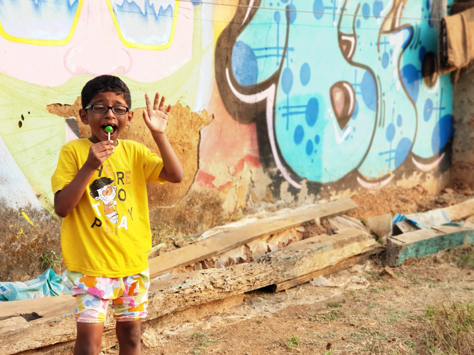 Nandu in front of a graffiti wall in Chaudi-South Goa
